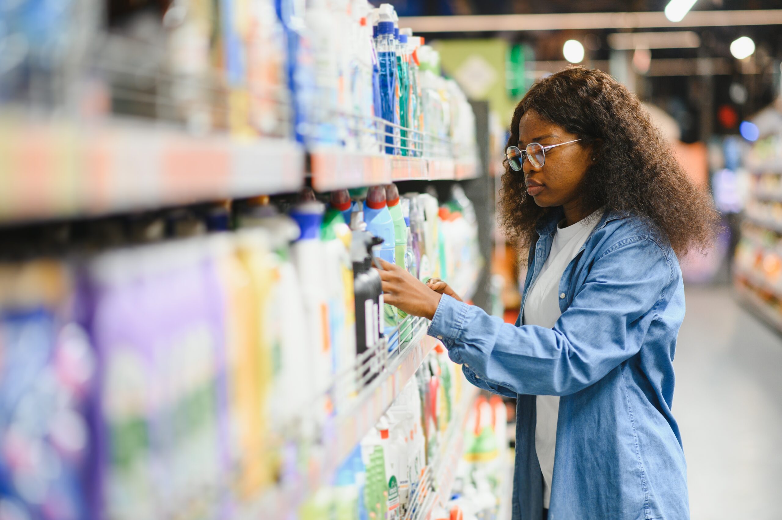 Young woman checking labels of a product in an African supermarket