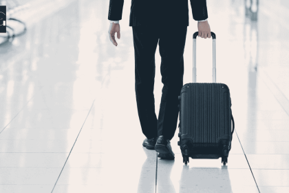An executive traveling with a carry on bag