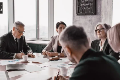 5 people in a meeting room discussing a business continuity plan